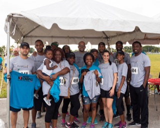 The Alliance Law Firm team gathered under a tent at the 4KIDS BiG Cardio event